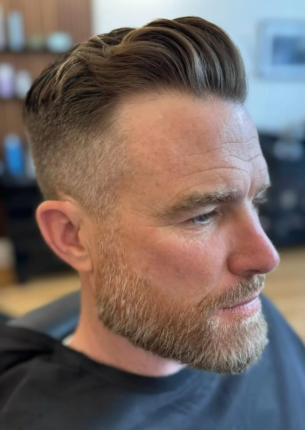 Finished men's haircut — short tapered cut with moustache